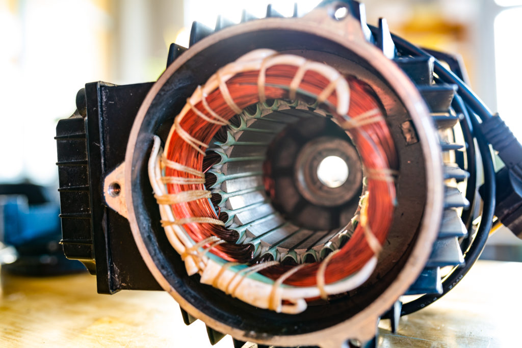 Close-up of an unidentified part with a thick bundle of copper wire for the production of air transport in the production of military equipment. The concept of modern military technology