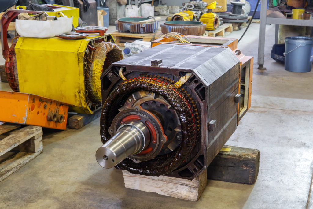 disassembled large industrial electric motor in the repair process in the workshop